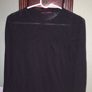 A long sleeve black shirt with a pocket